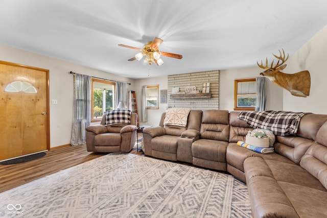 living room with light hardwood / wood-style flooring and ceiling fan