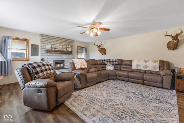 living room featuring ceiling fan and dark wood-type flooring