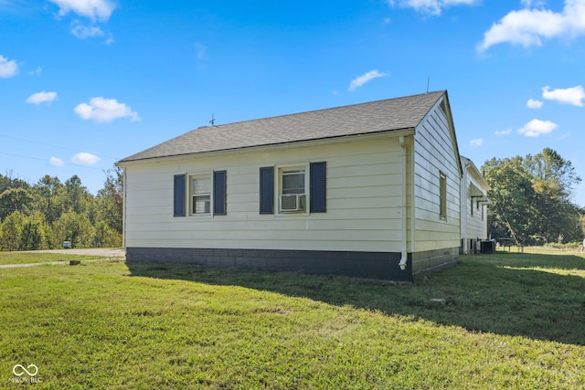 view of side of home with a yard