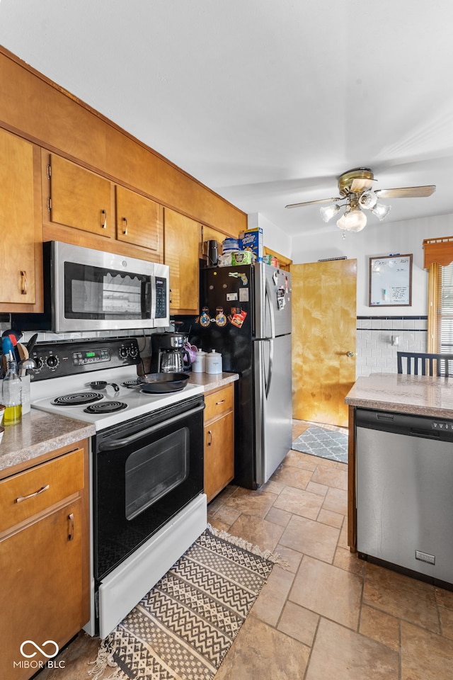 kitchen featuring appliances with stainless steel finishes, ceiling fan, and tasteful backsplash