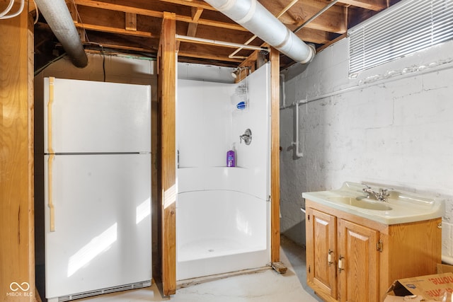 bathroom featuring concrete floors, a shower, and vanity