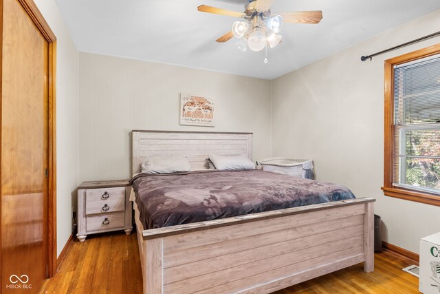 bedroom featuring light wood-type flooring, ceiling fan, and a closet