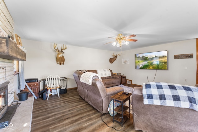 living room with dark hardwood / wood-style flooring and ceiling fan