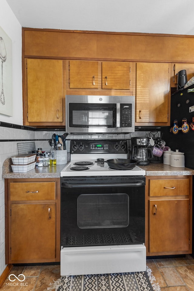 kitchen with white electric range and backsplash