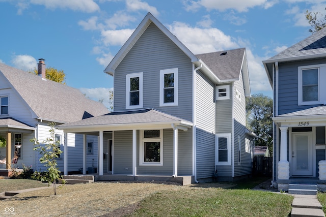 front facade featuring a front yard and covered porch