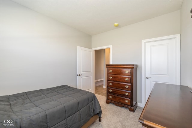 carpeted bedroom with lofted ceiling