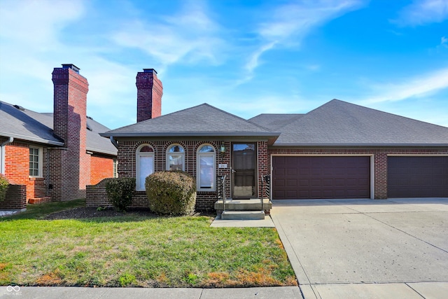 view of front of house with a front lawn and a garage