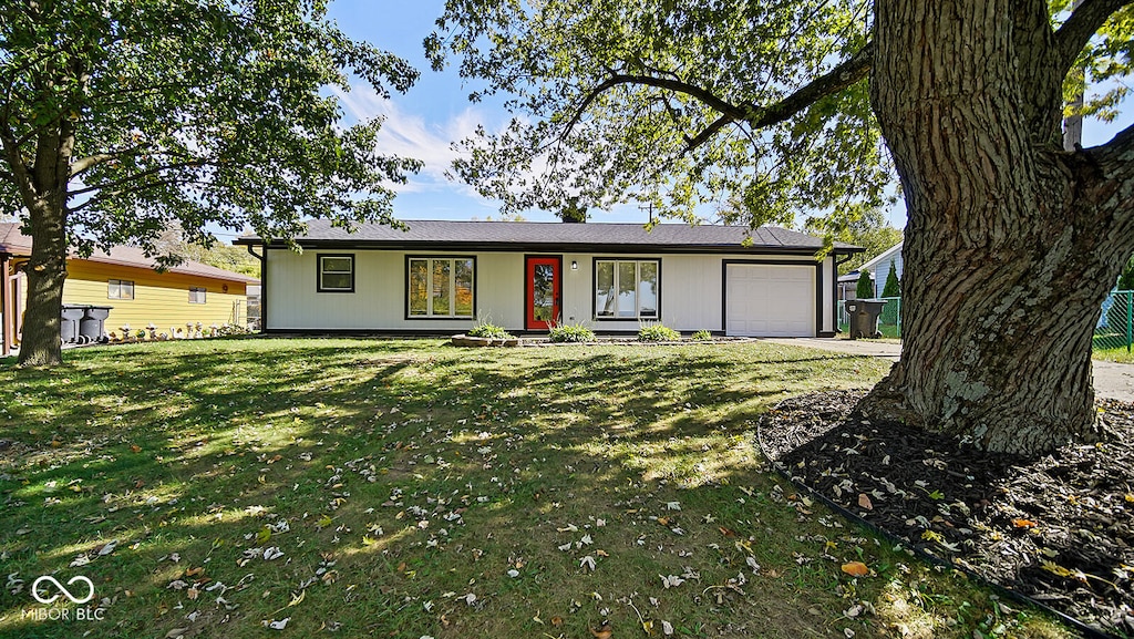 ranch-style home with a front yard and a garage