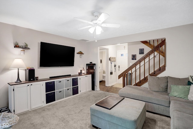 living room featuring ceiling fan and light carpet