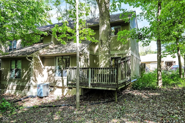 back of house with central AC and a deck