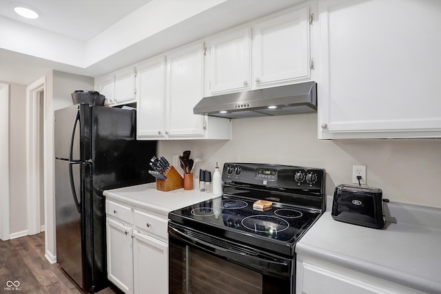 kitchen with dark hardwood / wood-style floors, black appliances, and white cabinetry