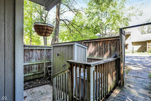 wooden terrace featuring a shed