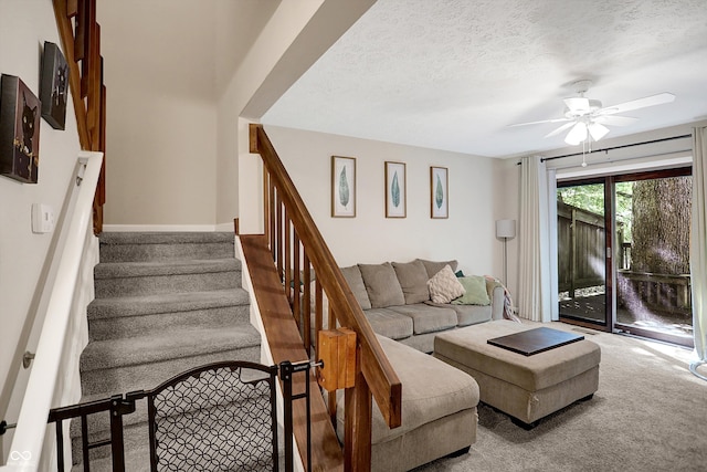 living room featuring ceiling fan, a textured ceiling, and hardwood / wood-style floors