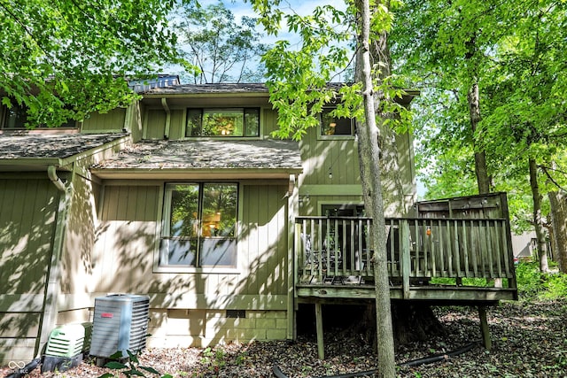 back of house with a wooden deck and central air condition unit