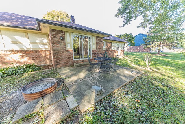 back of property featuring a yard and a patio area