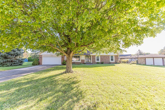 view of front of property featuring a garage and a front lawn