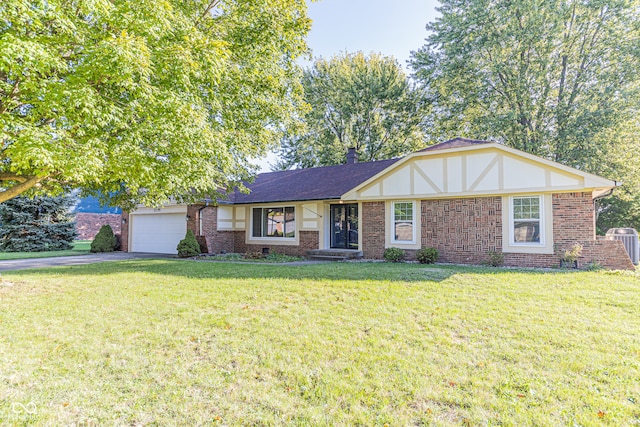 view of front of property with a front yard and a garage