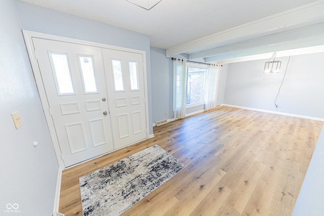 foyer with wood-type flooring and a textured ceiling