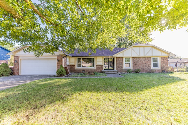 view of front of property featuring a garage and a front lawn