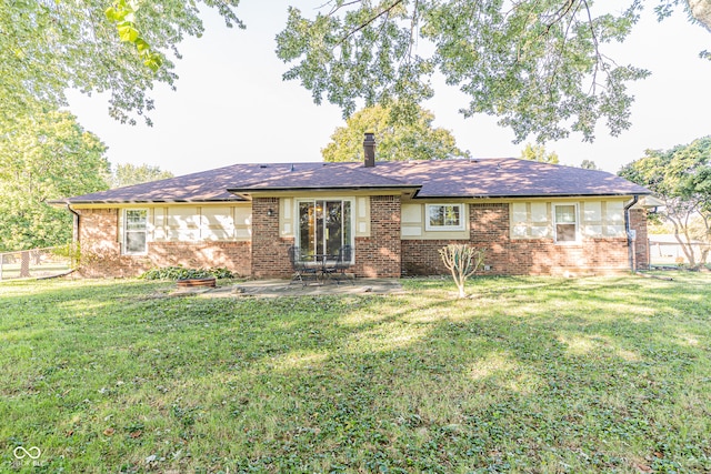 back of property featuring a patio area and a lawn