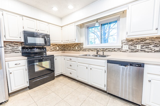 kitchen featuring black appliances, sink, white cabinetry, light tile patterned floors, and a textured ceiling