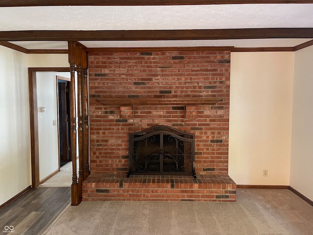 details with wood-type flooring, a textured ceiling, a brick fireplace, and crown molding