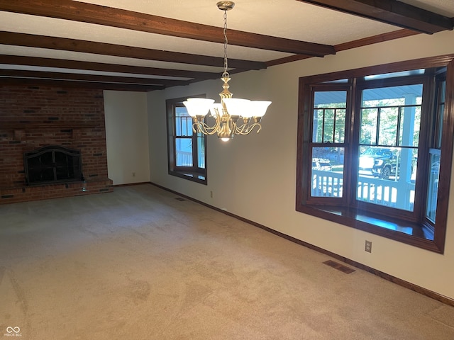 unfurnished living room with a notable chandelier, beam ceiling, a fireplace, and carpet flooring