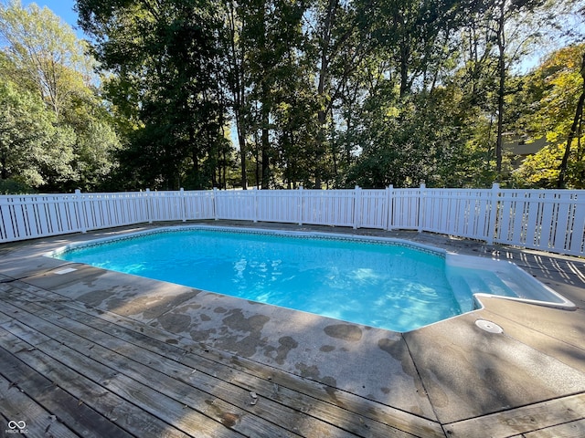 view of swimming pool featuring a deck