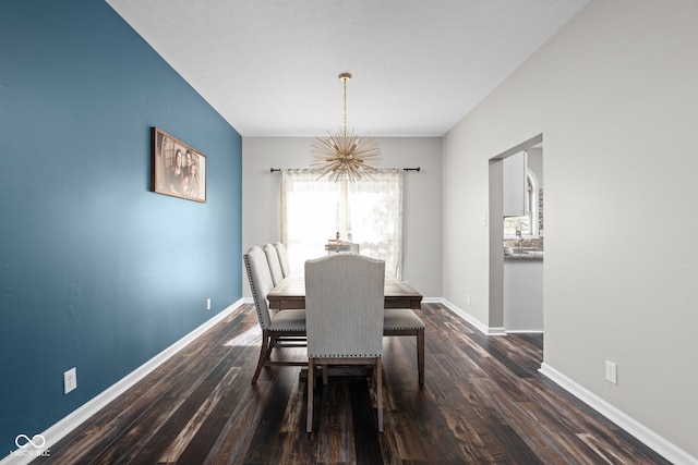 dining room with an inviting chandelier and dark hardwood / wood-style floors