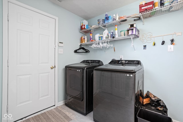 clothes washing area with washer and clothes dryer