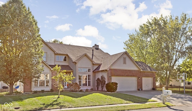 view of front of house with a front yard and a garage