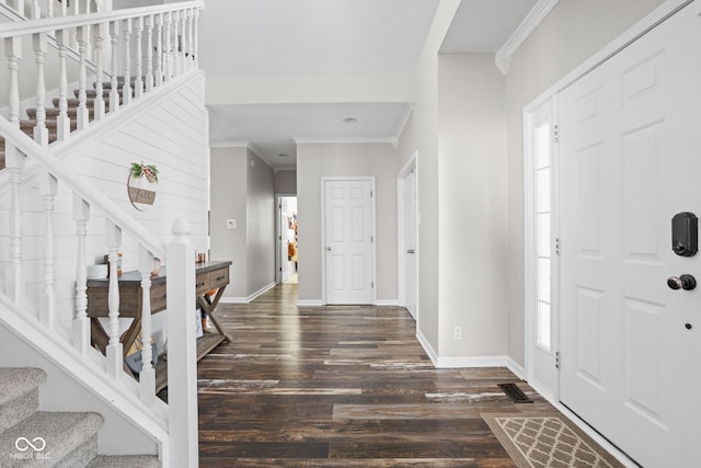 foyer with ornamental molding and dark wood-type flooring