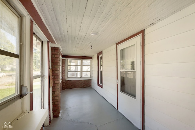 unfurnished sunroom featuring wooden ceiling