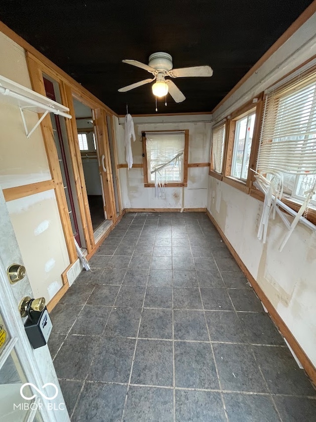 interior space featuring ornamental molding, a wealth of natural light, and ceiling fan