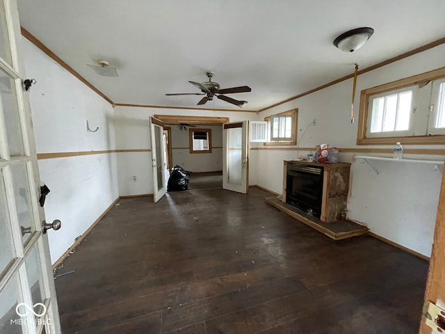 interior space featuring ceiling fan, ornamental molding, and dark wood-type flooring