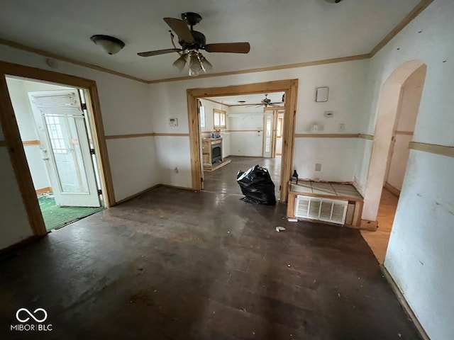 interior space with ornamental molding and ceiling fan