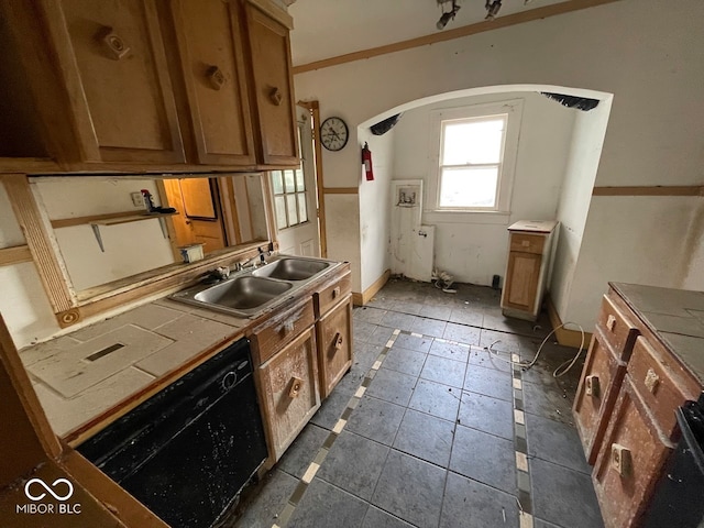 kitchen featuring dark tile patterned floors, sink, crown molding, tile countertops, and dishwasher