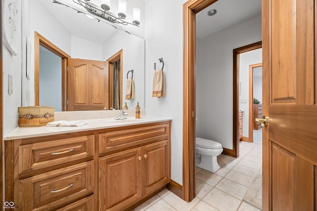 bathroom featuring vanity, toilet, and tile patterned floors