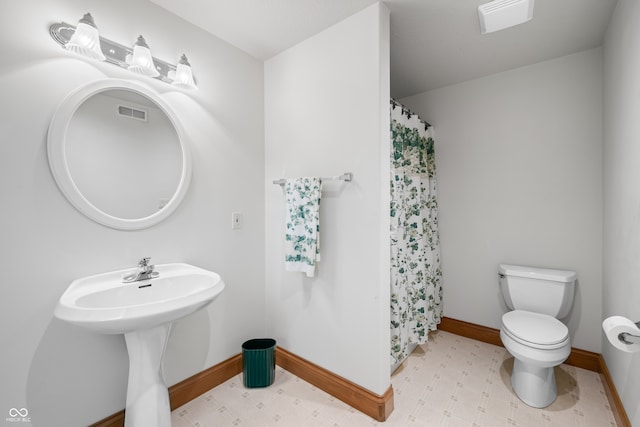 bathroom featuring toilet and a shower with shower curtain