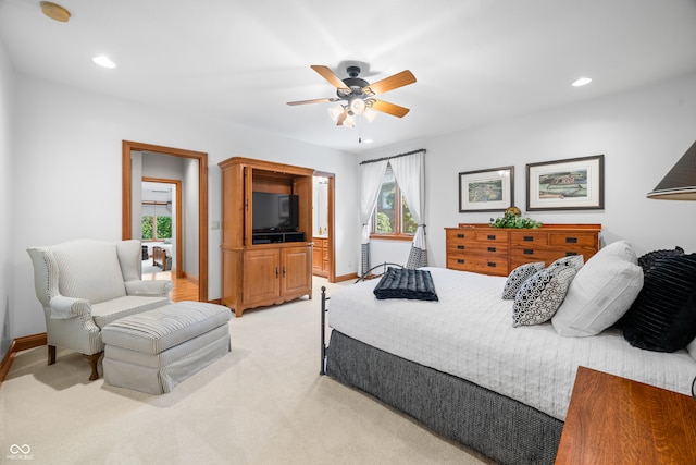 bedroom featuring light colored carpet and ceiling fan