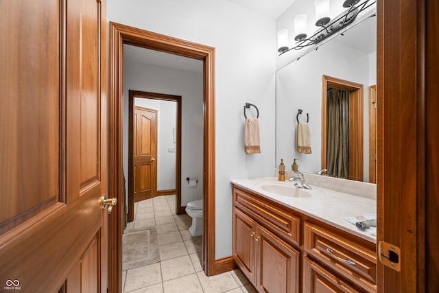 bathroom with vanity, toilet, and tile patterned floors