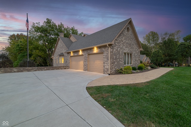 view of front of property featuring a yard and a garage