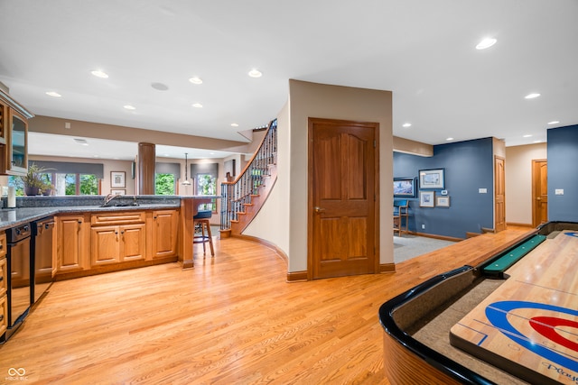 playroom with light hardwood / wood-style floors and sink