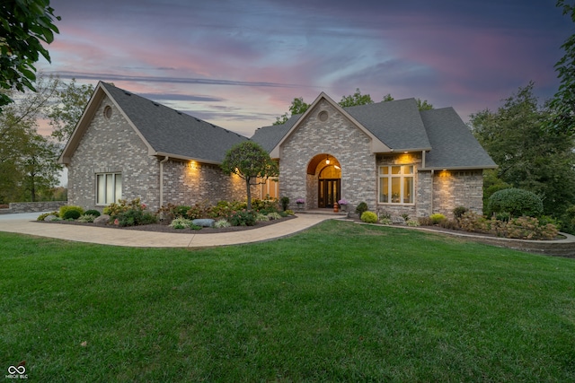 french country style house featuring a lawn