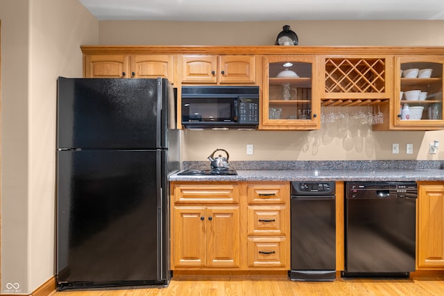 kitchen featuring black appliances and light wood-type flooring