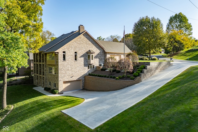 view of side of property with a yard and a garage