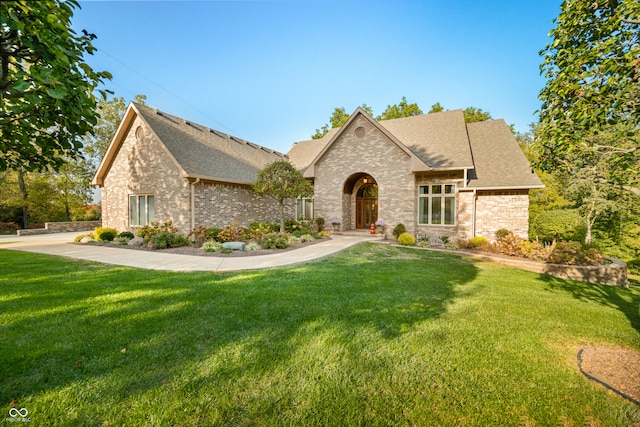 french country inspired facade featuring a front lawn