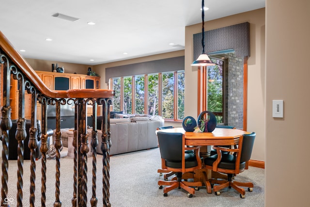 dining space featuring light carpet