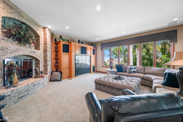 carpeted living room featuring a brick fireplace