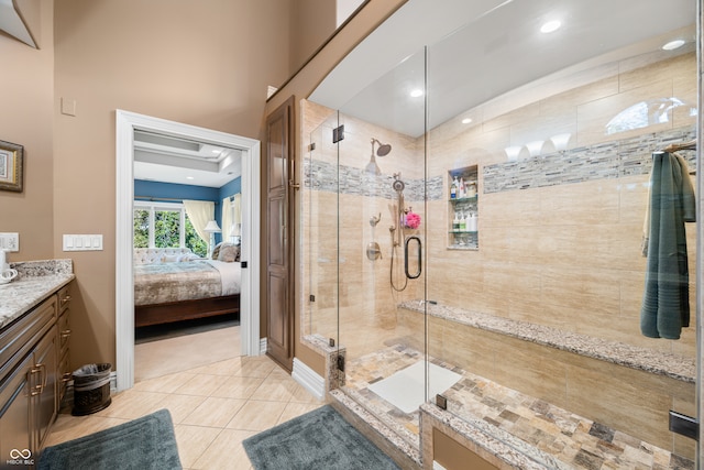 bathroom with vanity, tile patterned floors, and a shower with shower door